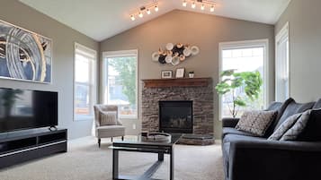 Smart TV, fireplace, books, computer monitors