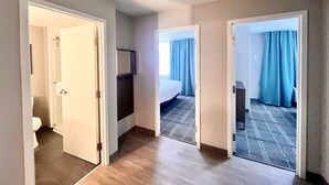 A hotel room with a bed, a desk, and a bathroom. - Staybridge Suites Federal Way - Seattle South by IHG (Federal Way)