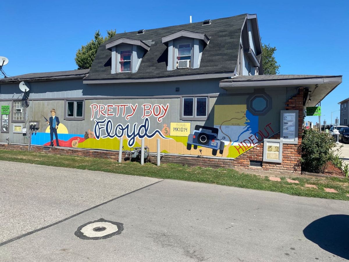 A building with a mural of a cartoon character and the name 'Pretty Boy Floyd' on the side.