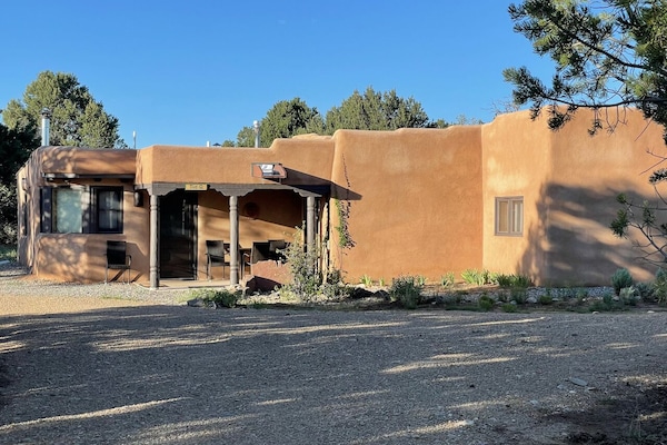 The Q house is a beautiful adobe home set in a beautiful secluded forest.