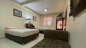 A bedroom with two beds, a sofa, a nightstand, and a ceiling light. - AERO-GDL RESIDENCE (Las Pintitas)