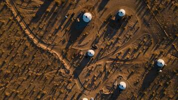 An aerial view of a facility with multiple spherical structures, likely storage tanks, arranged in a pattern with clear pathways between them.