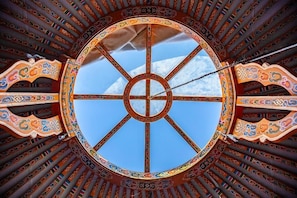 A circular architectural design with a central window and intricate patterns.