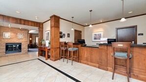 A spacious lobby with a fireplace, wooden bar area, and modern lighting fixtures. - 1 Bedroom | Indoor Pool + Hot Tub Access (Albuquerque)