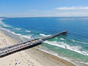 A pier extending into the ocean with beach houses and a sandy beach. - 1 Block to Beach/Restaurants/Bars, Remodeled, 2-Car Garage w/fee, Yard, Sleep 10 (San Diego)