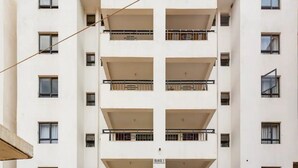 A multi-story building with balconies and windows, labeled "BLOCK 2". - Lovely private room with free parking on premises (Nairobi)
