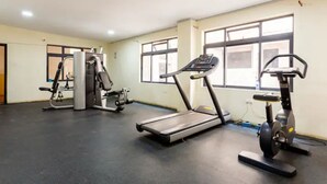 A gym with treadmills, a stationary bike, and weight machines. - Clean and cozy loft (Nairobi)