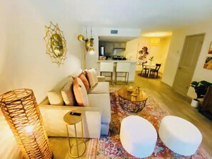 Relax in this stylish living room with a sofa, coffee table, and patterned rug.