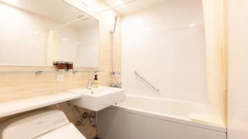 A modern bathroom with a white sink, mirror, and bathtub.