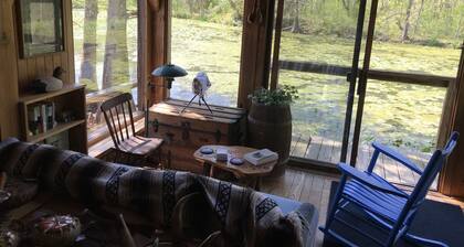 Peacocks, blacksmithing, buffalo, wildlife, a studio cabin by the pond.
