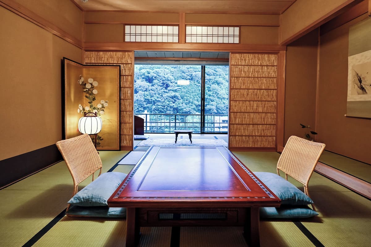 A traditional Japanese room with tatami flooring, a low table, and shoji screens.