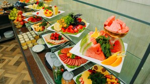 A buffet with various fruits, vegetables, and cheeses. - FAYZ HOTEL (Urgench)
