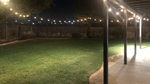 A covered patio area with string lights.