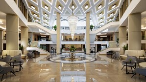 A spacious lobby with a central chandelier, multiple seating areas, and a polished floor. - Kings Valley Medical & Spa Hotel (Kazanlak)