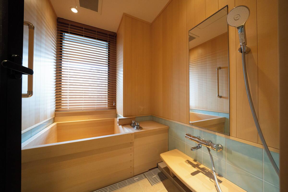A modern bathroom with a bathtub, a sink, and a shower.