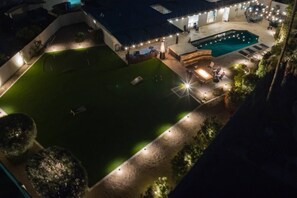 A rooftop pool area with a hot tub, seating, and ambient lighting. - Perfect for Families! Private Pool, Spa & BBQ, Near Shopping, Dining, Mayo Clinic + Free Golf (Phoenix)