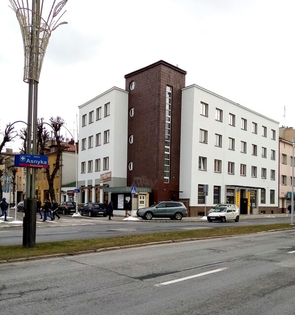 A multi-story building with a central brown section, likely a hotel or office. - HOSTEL OMEGA (Rzeszów)