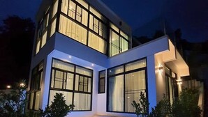 A modern two-story house with a swimming pool in the foreground. - King Size Sea View Villa + Pool + Rooftop Skydeck  (Kathu)