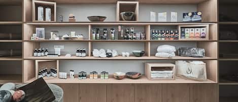 A wooden shelving unit with various kitchenware and food items.