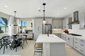 Enjoy cooking in this well-equipped kitchen with a central island, ample counter space, and integrated appliances.