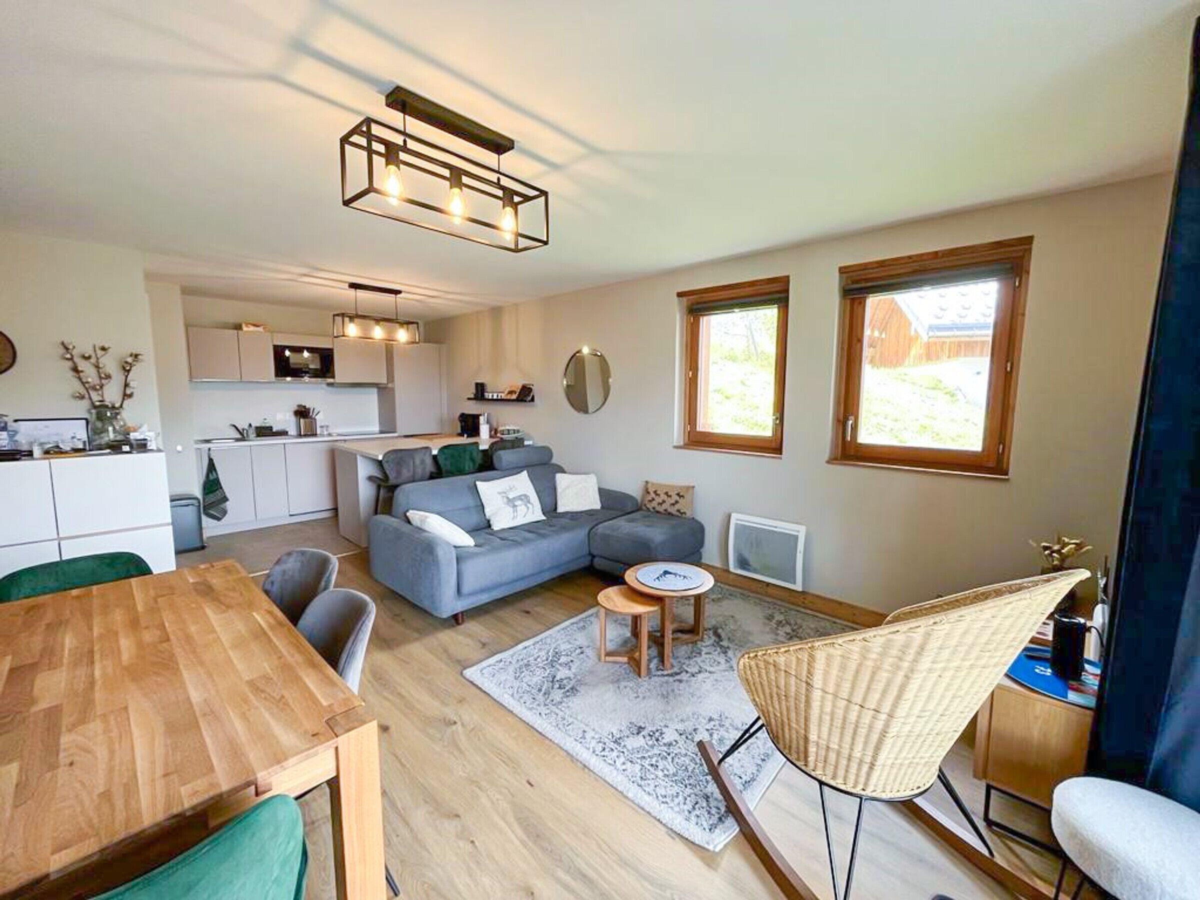 A modern living space with a kitchen, dining area, and seating area.