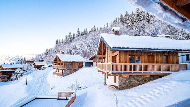 A wooden cabin with a stone foundation, surrounded by snow-covered trees and a clear sky. - 3* Chalet Valmorel, ski-in/ski-out, 3 bedrooms, parking, WIFI (Valmorel)