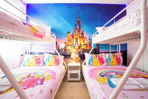 A children's room with bunk beds, a Disney castle mural, and a night sky theme.