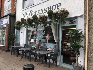 A storefront with a sign reading 'No.4 Teashop' and outdoor seating with tables and chairs. - Hardwick Haven, Sedgefield - Near Hardwick Hall (Stockton-on-Tees)