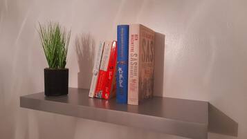 A bookshelf with books and a potted plant.