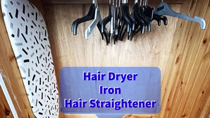 A hair care station with a hair dryer, iron, and straightener.