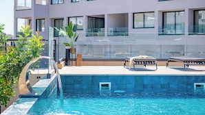 A modern hotel with a rooftop pool, glass balustrades, and a clear view of the cityscape. - Sanders River Plaza - Fancy 2-bdr Apt With Balcony (Limassol)