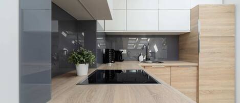 Fridge, stovetop, dishwasher, coffee/tea maker