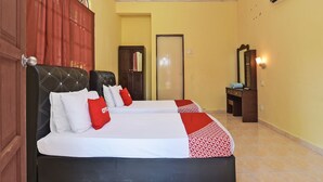 A hotel room with two beds, a wardrobe, a mirror, and an air conditioning unit. - Oyo 90640 D'village River & Cafe Chalet (Kuala Tembeling)