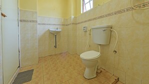A bathroom with a toilet, sink, and shower. - Oyo 90640 D'village River & Cafe Chalet (Kuala Tembeling)