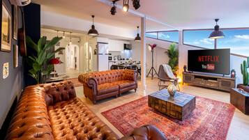 Panorama appartement, meerdere bedden, uitzicht op zee | Woonruimte | Een 50-inch ledtelevisie met satellietzenders, een televisie en Netflix