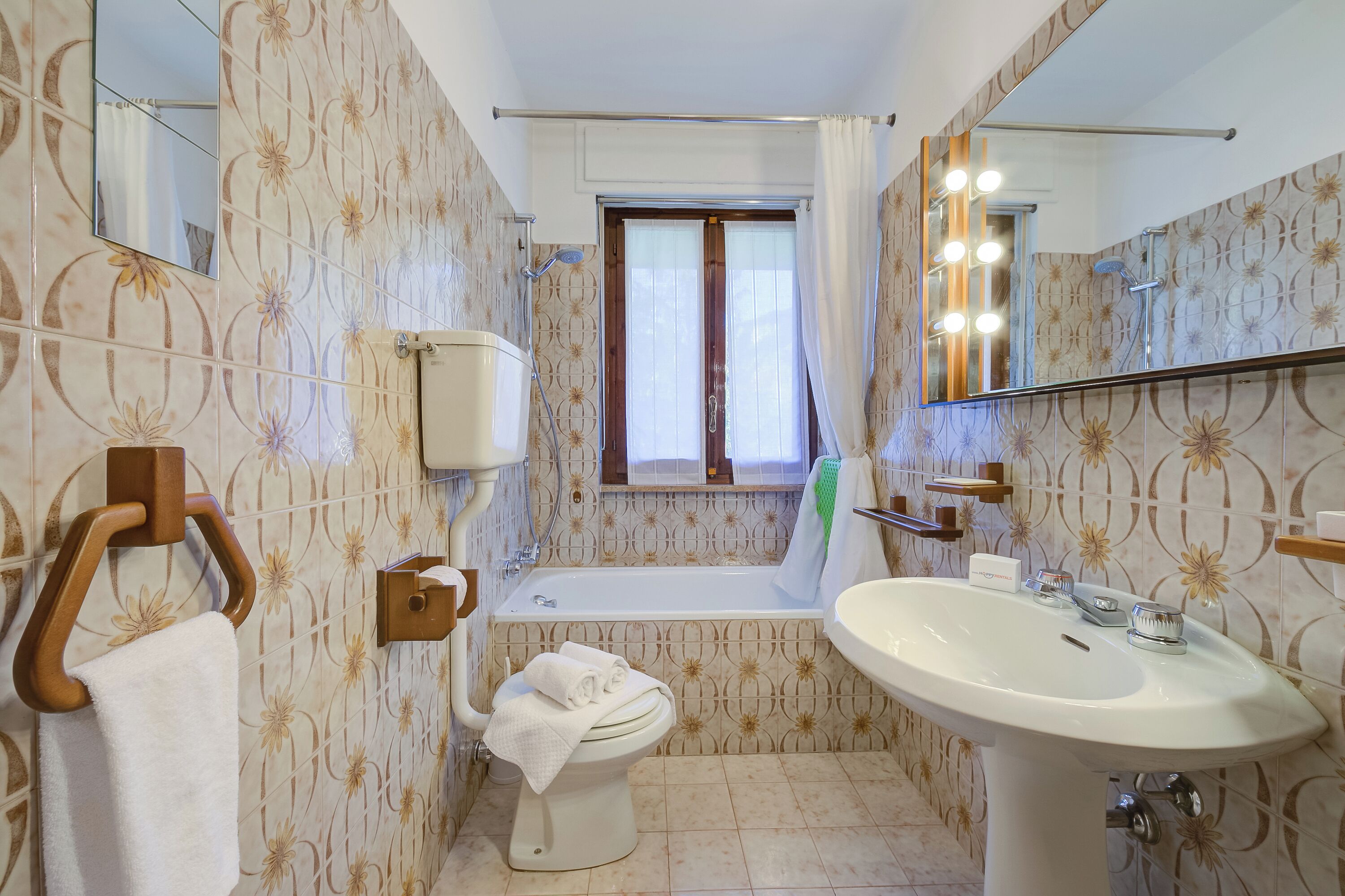 A bathroom with a toilet, sink, and bathtub.