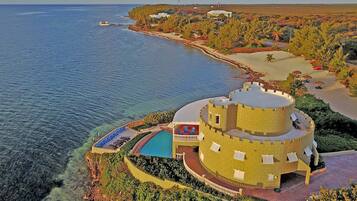 Experience the castle-like resort with a pool and sea access, surrounded by lush vegetation and beautifully maintained gardens.