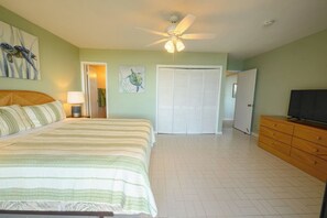 A bedroom with a bed, a ceiling fan, a wardrobe, and a television. - 3-bedroom condo w/ amazing Ocean views! (Christiansted)