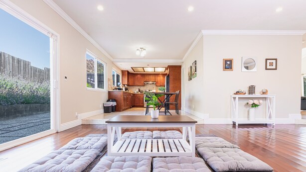 A spacious kitchen with wooden cabinets, a dining table with four cushioned benches, and a white console table with decorative items. - Maison du Lavande, artzy 4Br House, gateway 2 Napa (Vallejo)