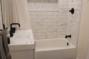 Combined shower/tub, hair dryer, towels, soap