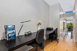 Work in comfort with a desk, book, and natural views.