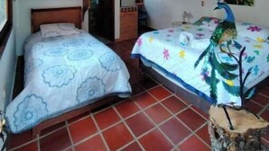 A room with two beds, a wooden ceiling, and a tiled floor. - Bird Cabin (Antioquia)