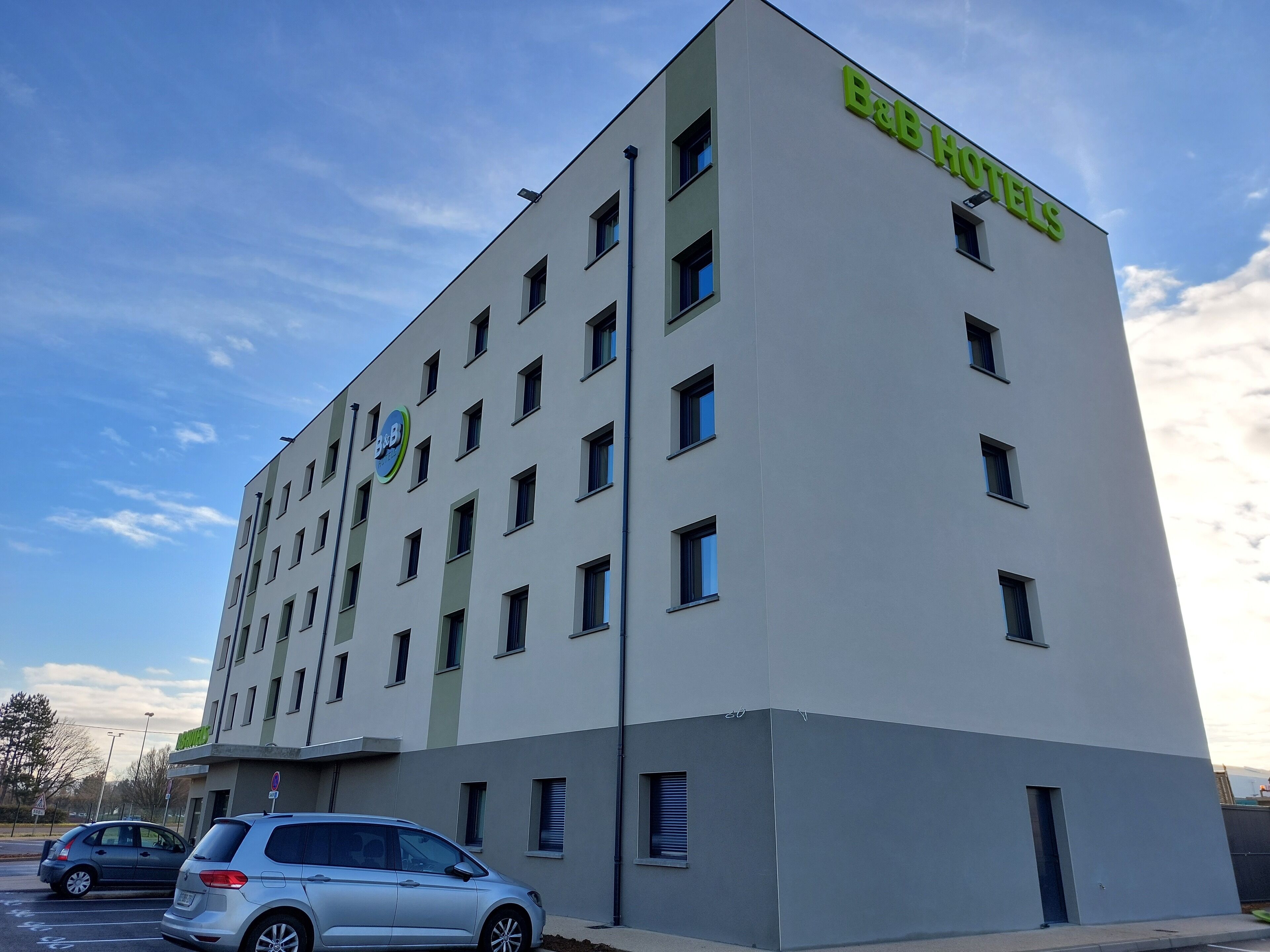 A B&B hotel building with a modern design, featuring multiple windows and a prominent B&B logo.