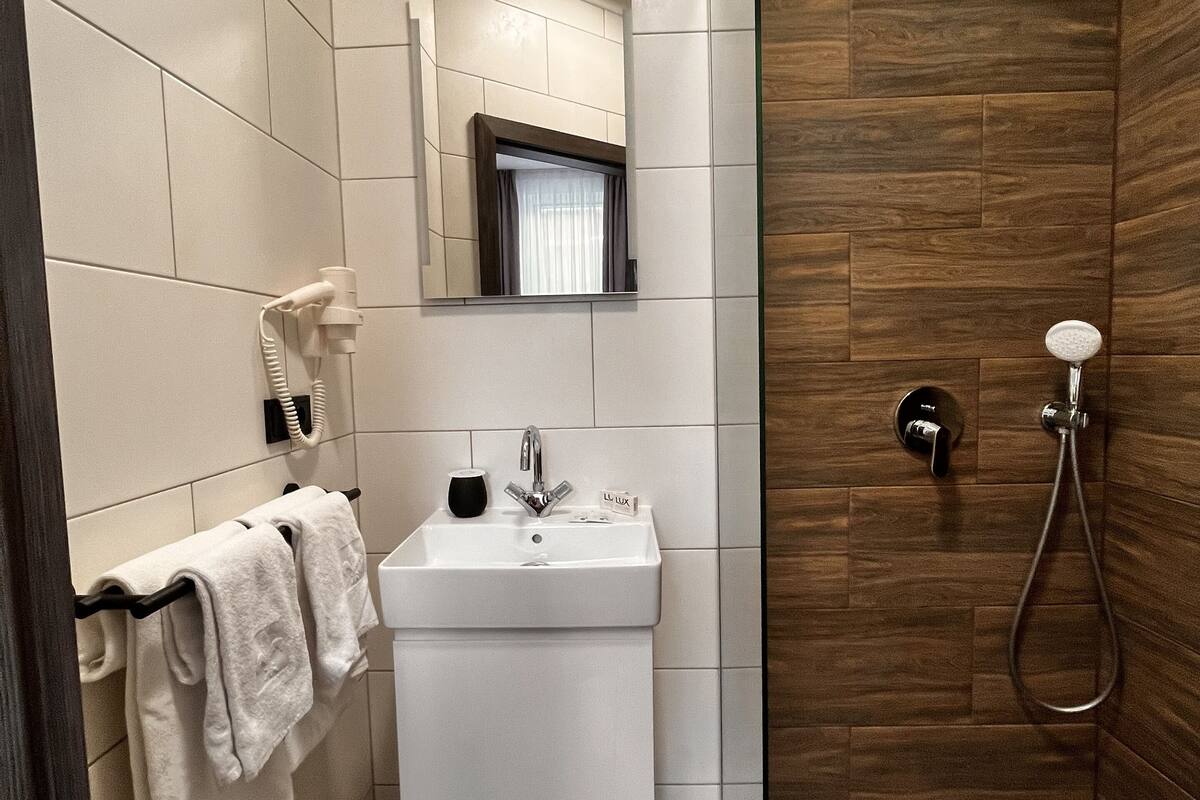 superior quadruple room | bathroom | hair dryer, slippers, heated floors, towels