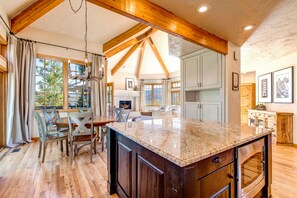 Enjoy cooking in this well-equipped kitchen with a large island, cabinets, and an oven.