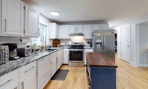 Enjoy cooking in this well-equipped kitchen with a refrigerator, oven, and microwave.