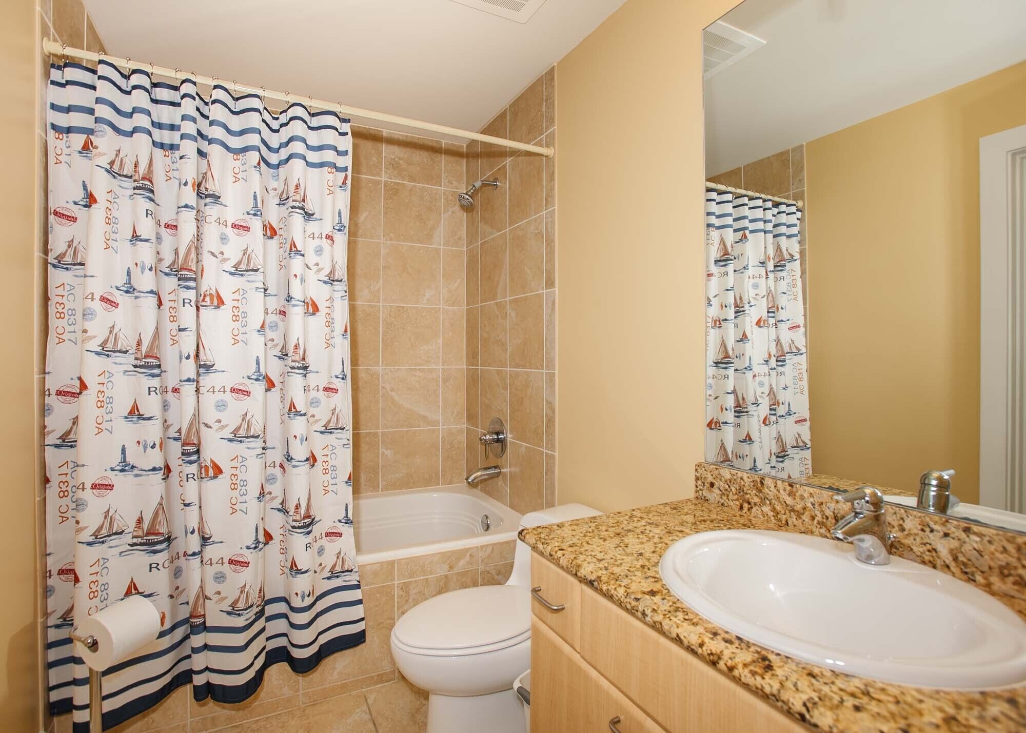 A bathroom with a shower, toilet, and sink.