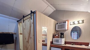 A compact kitchen with a microwave, sink, and wooden cabinets. - Blackhills Cabin 2 Twin Beds in Sturgis, SD.Close to Downtown, Deadwood, Spearfish and Mt. Rushmore (Sturgis)