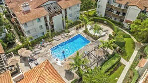 A residential area with a swimming pool surrounded by lush greenery and a well-maintained garden. - Ritz Pointe Paradise!  Walking distance to the beach... (Dana Point)