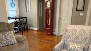 A living room with a sofa, armchair, and a coffee table with decorative items. - Clean and cozy 3 bdrm one bath home in the heart of Rupert.  (Rupert)